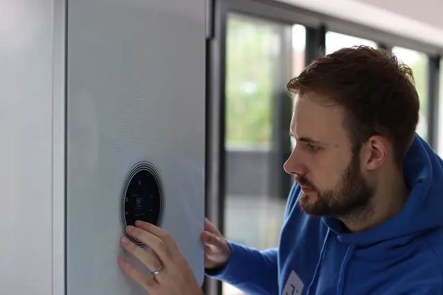 Engineer checking the display on a wall-hung combi boiler