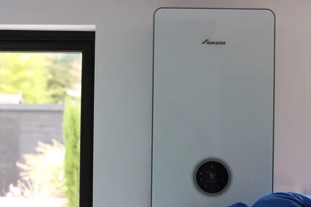 White wall-hung combi boiler mounted in a modern kitchen